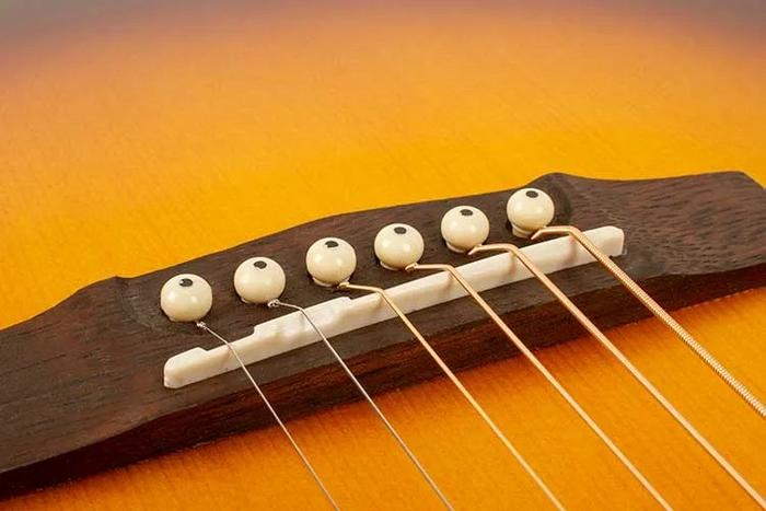 Acoustic Properties of Guitar Bridges