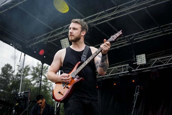 Hollowstar performing live at a music festival, representing musicians and artists engaged in live performances.