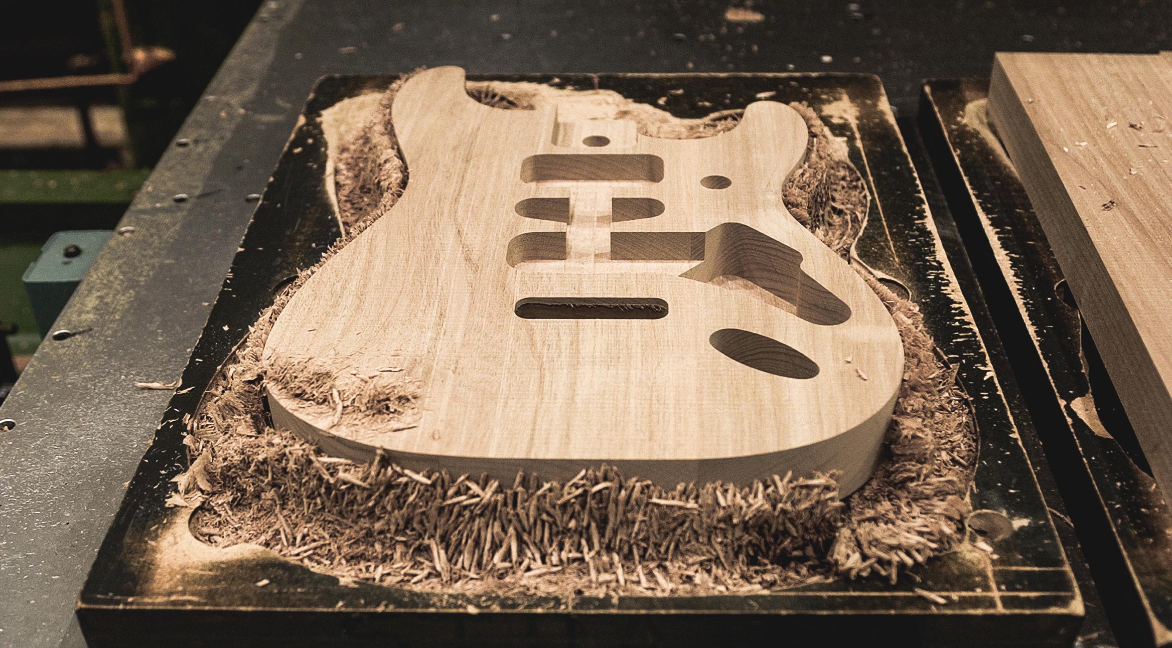 Comparison of Ash and Alder tonewoods used in guitar bodies, highlighting their tonal differences.