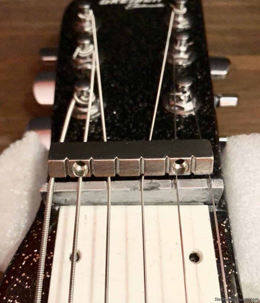 Photo of a lap steel with measurement markings/ruler from The Steel Guitar Forum, illustrating string height/action and scale measurements for setup and intonation.