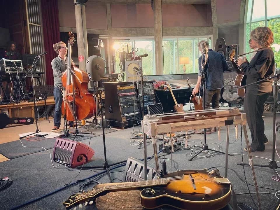 Recording studio/session work image titled 'Record Online or at a Recording Studio' — visually represents studio environment, equipment, and the tools/context relevant to tuning and setting up a lap steel for studio vs stage.